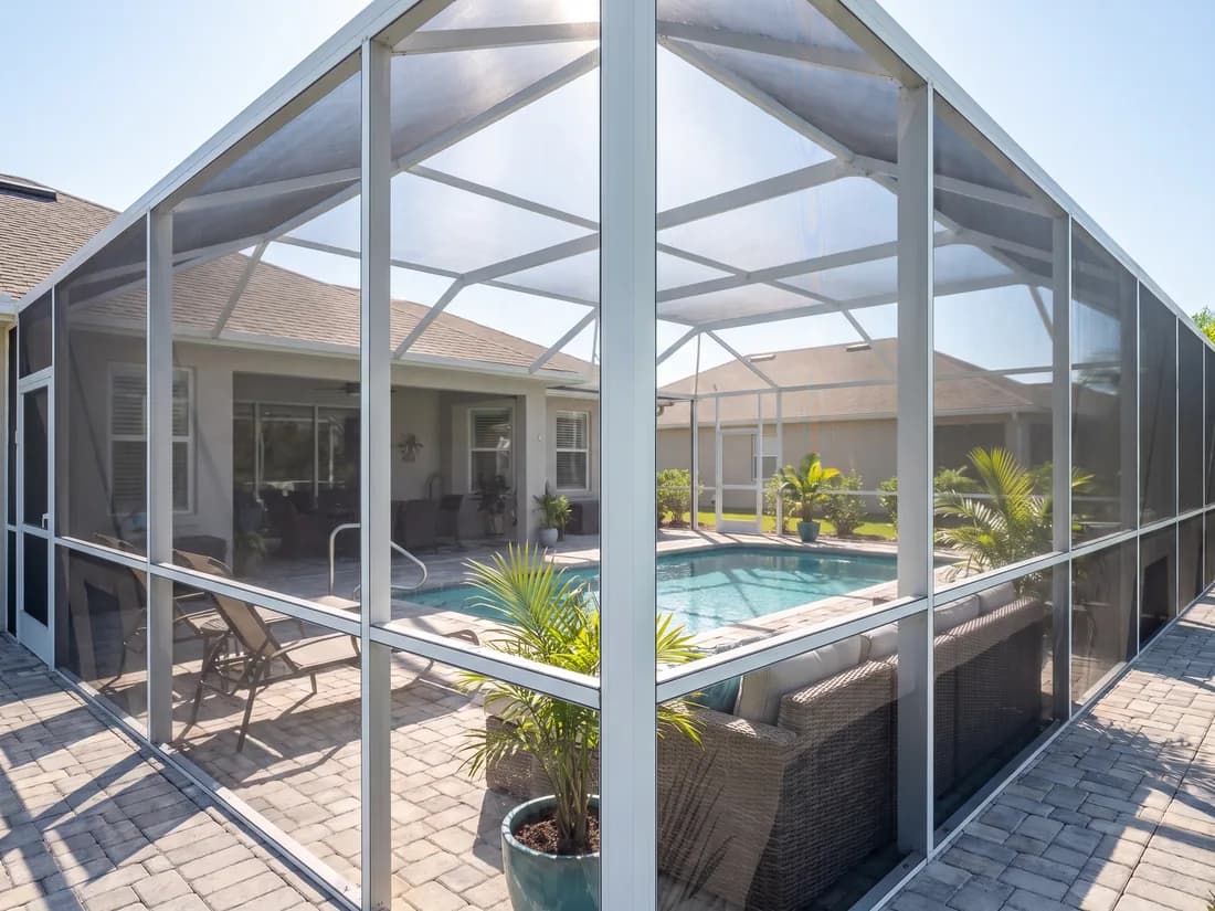 Screened lanai enclosure over a pool and patio